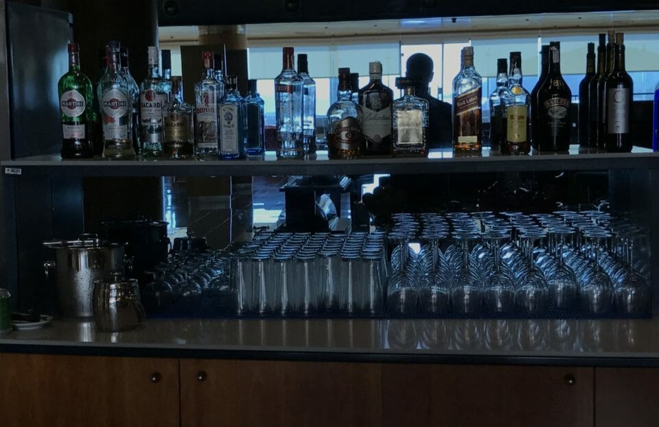 a shelf with bottles and glasses