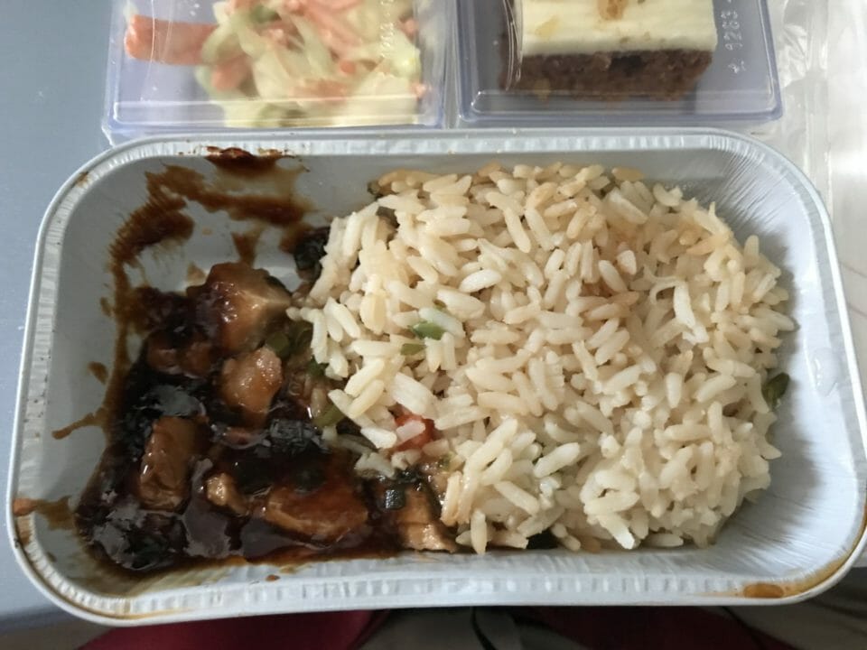 a tray of food with meat and rice