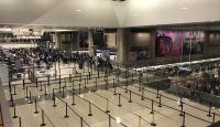 a large airport terminal with people walking around