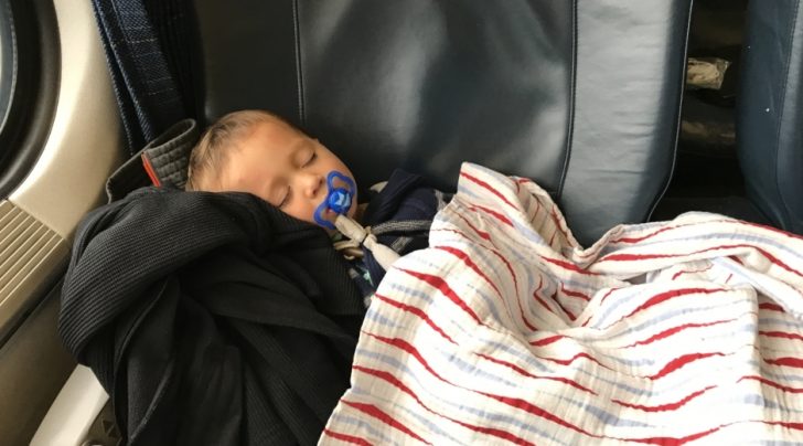 a baby sleeping on a couch