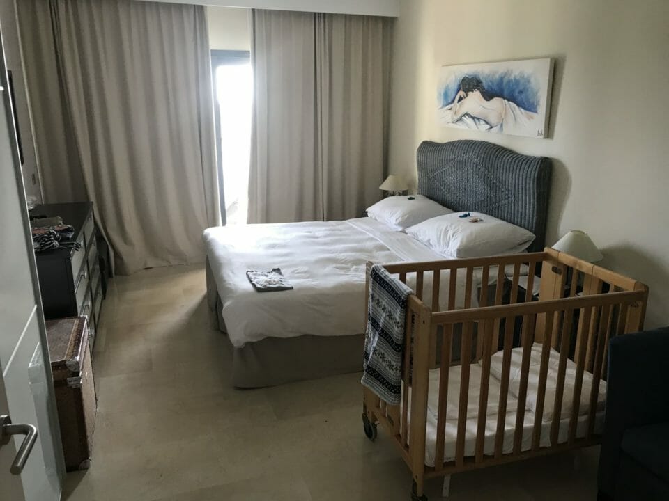 a room with a bed and crib