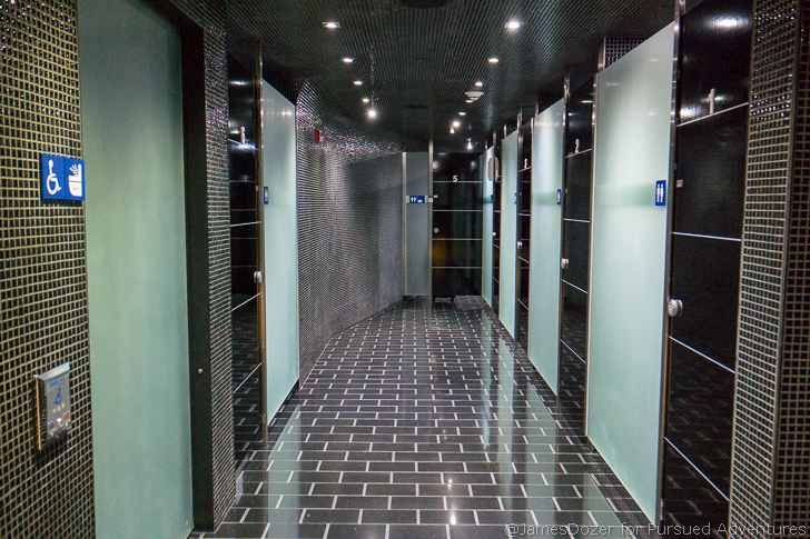a hallway with doors and a tile floor