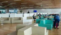 people sitting in a room with white and blue couches