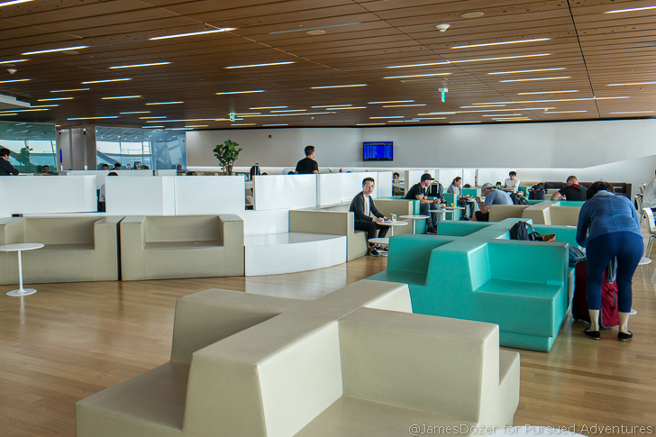 people sitting in a room with white and blue couches