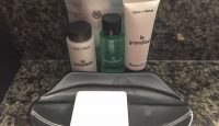 a group of toiletries and soap on a black tray