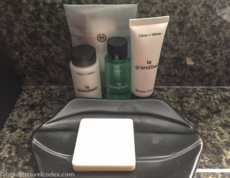 a group of toiletries and soap on a black tray