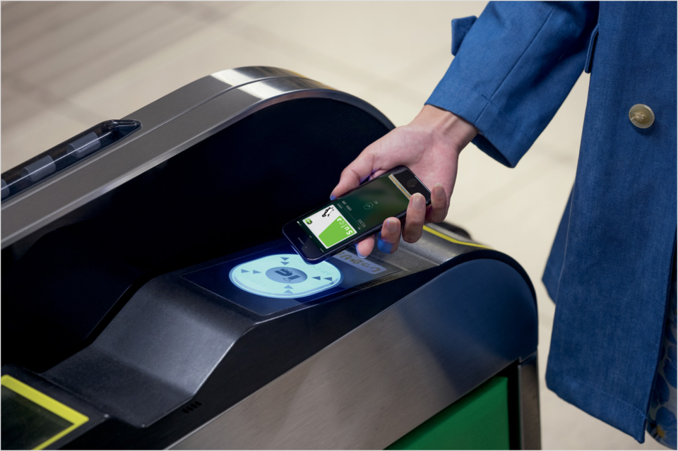 a person using a cell phone to scan a card