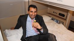 a man in a suit sitting on a bed
