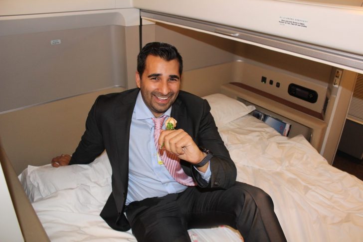 a man in a suit sitting on a bed