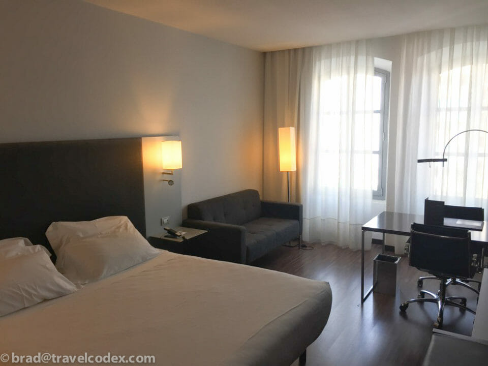 a room with a bed and a desk and a chair