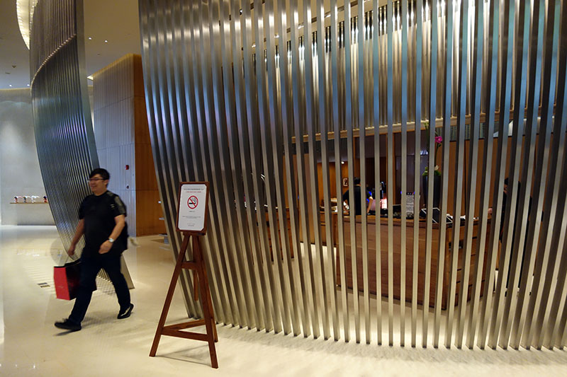 a man walking past a metal wall