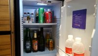 a refrigerator with bottles of beverages