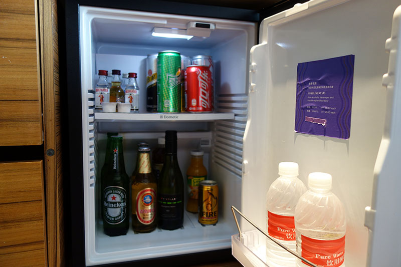 a refrigerator with bottles of beverages