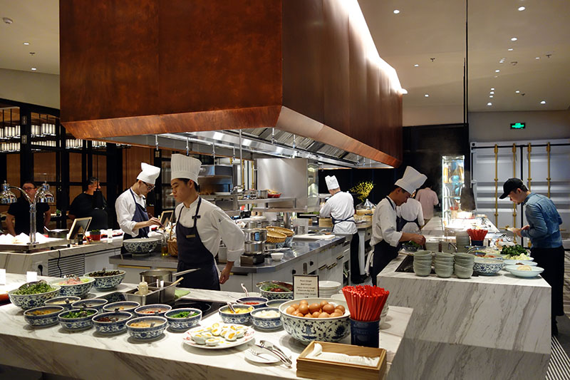 a group of chefs cooking in a kitchen