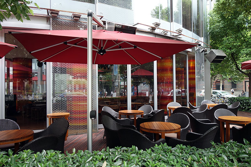 a patio with chairs and umbrella