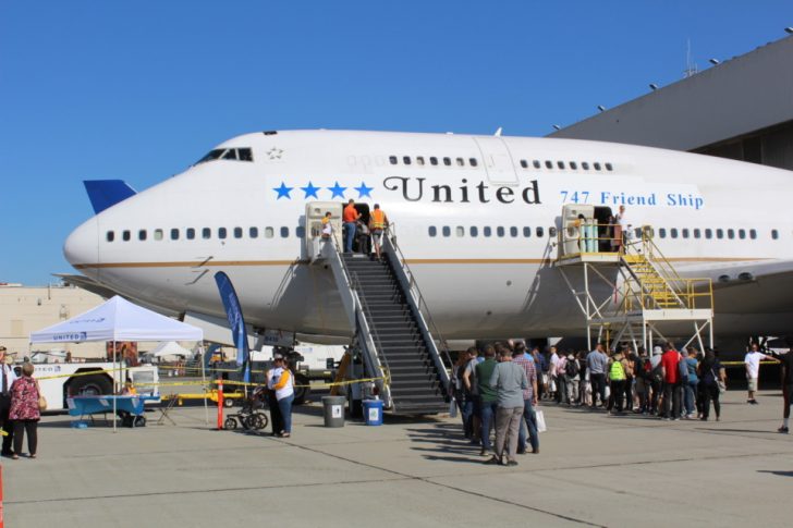 a group of people boarding an airplane