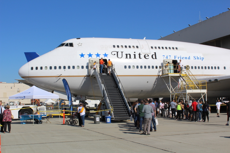 a group of people boarding an airplane