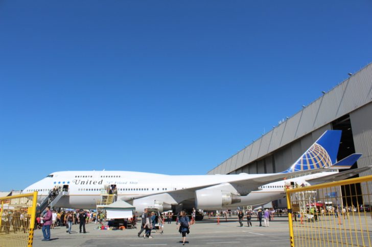 a large white airplane parked in a parking lot
