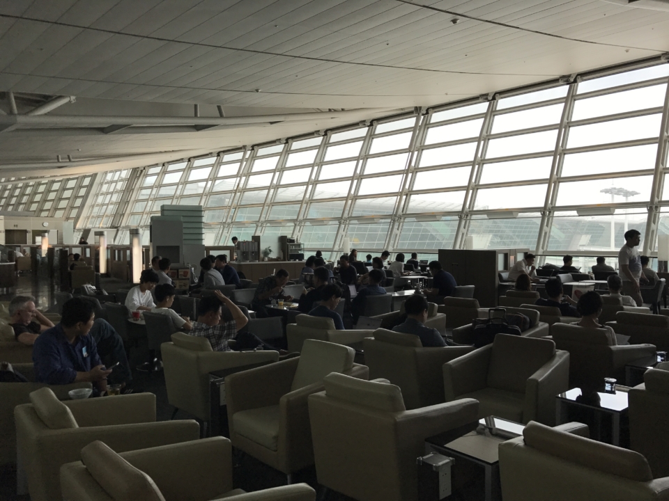 a group of people sitting in a room with windows