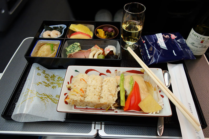 a plate of food and a glass of wine