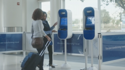 two women standing next to a machine