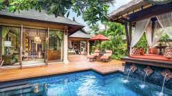 a pool with a waterfall in the middle of a house