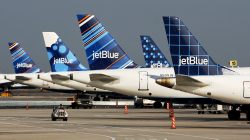 a group of airplanes parked on a runway