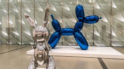 a silver and blue balloons on display