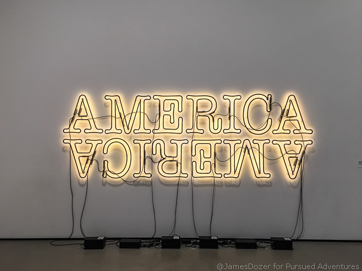 a lit up neon sign on a wall