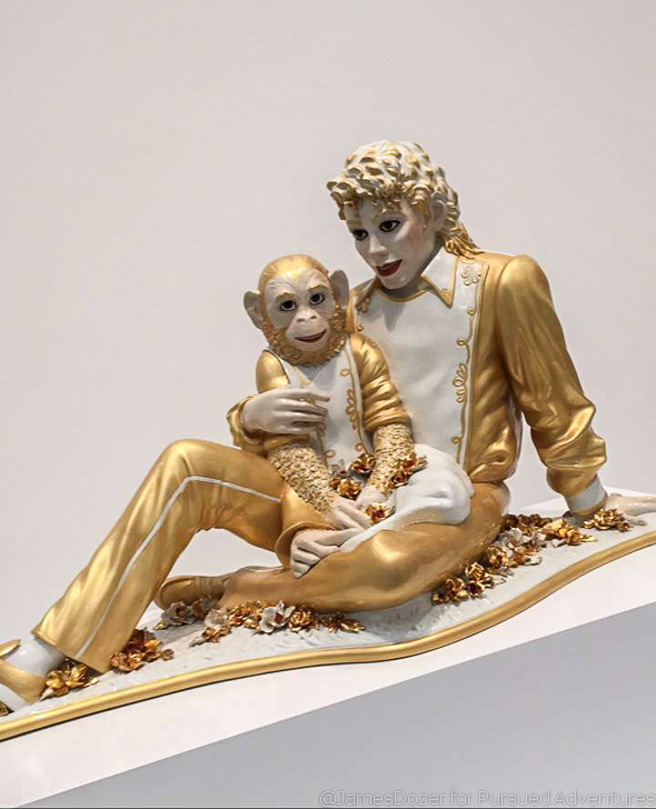 a statue of a man and a monkey