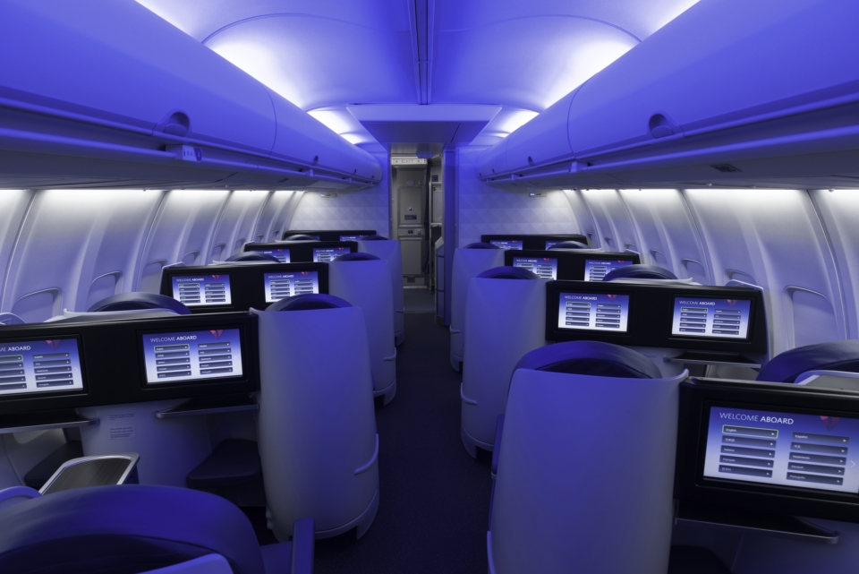 an airplane with rows of seats and monitors