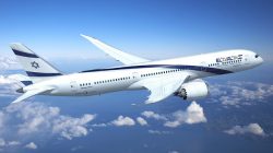 a white airplane flying in the sky