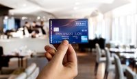 a hand holding a credit card