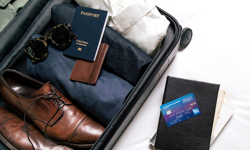 a suitcase with shoes and a credit card