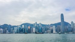 a city skyline with boats on the water