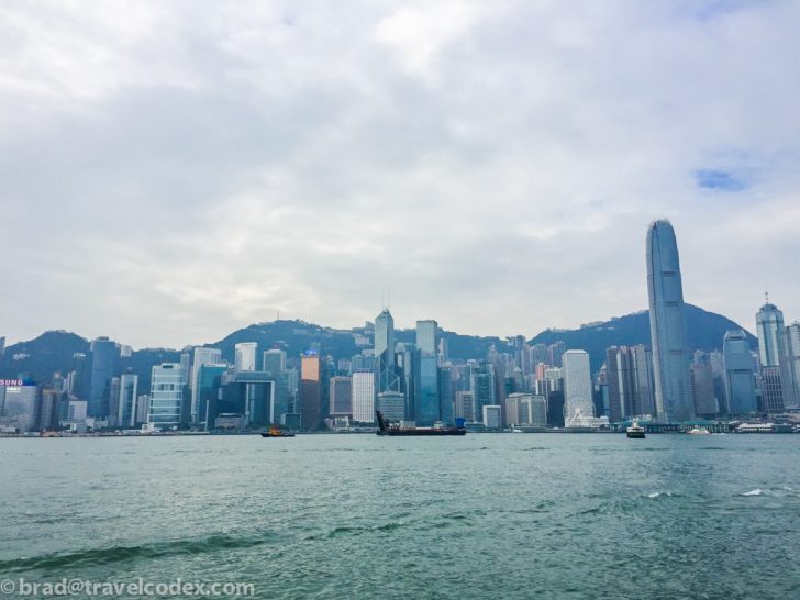 a city skyline with boats on the water