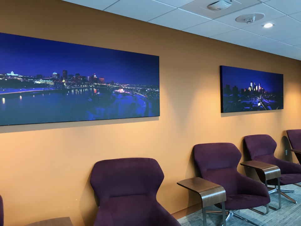 a row of chairs and a picture on the wall