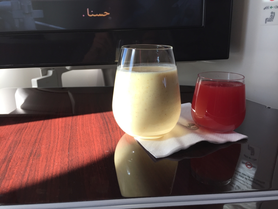 a glass of liquid and a drink on a table