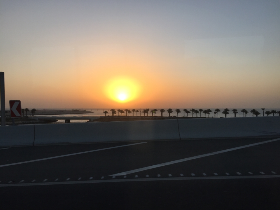 a road with a sunset in the background