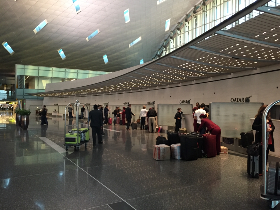 a group of people in a large room with luggage