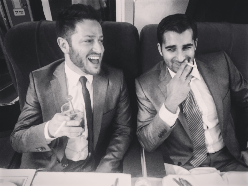 two men in suits sitting at a table