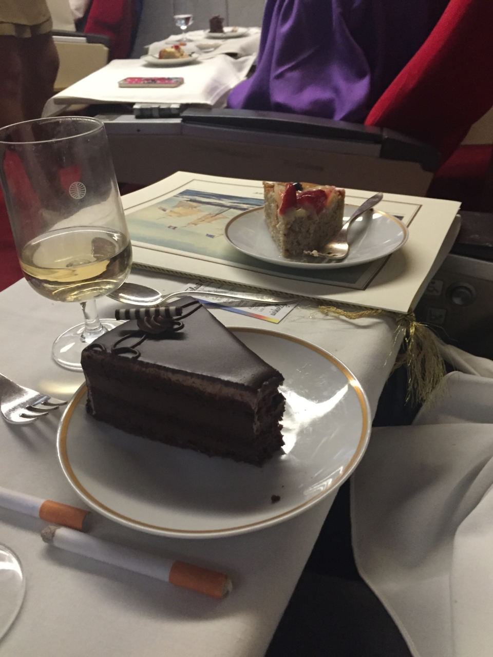 a plate of cake and a glass of wine on a table