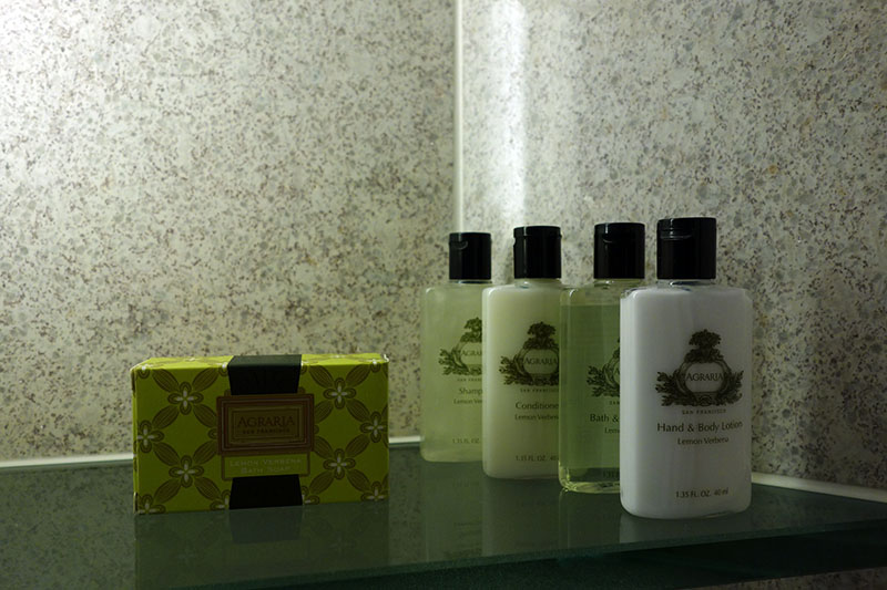 a group of bottles of body lotions and a box
