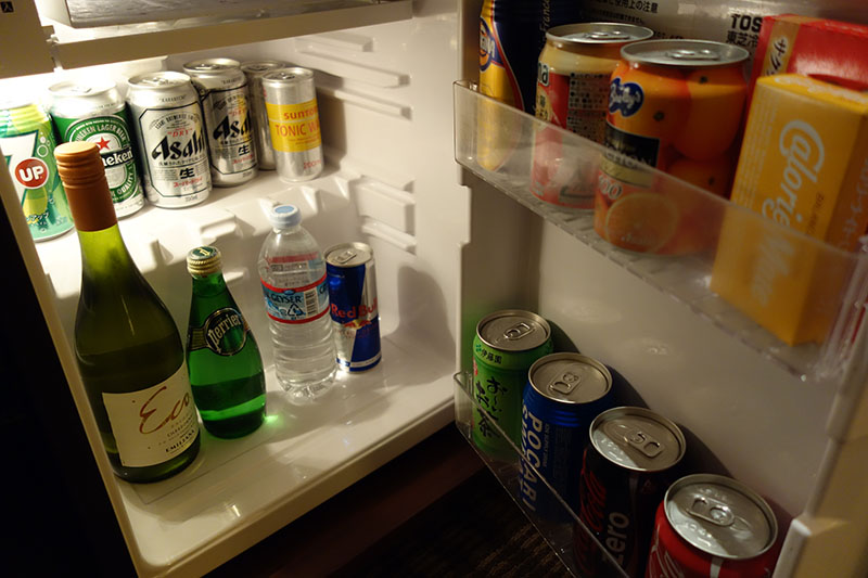 a refrigerator with drinks and cans