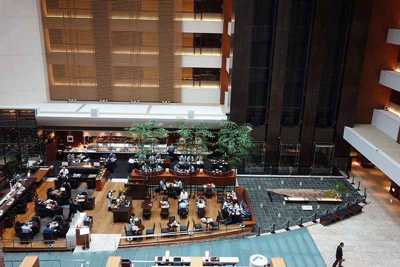 a group of people sitting at tables in a large building