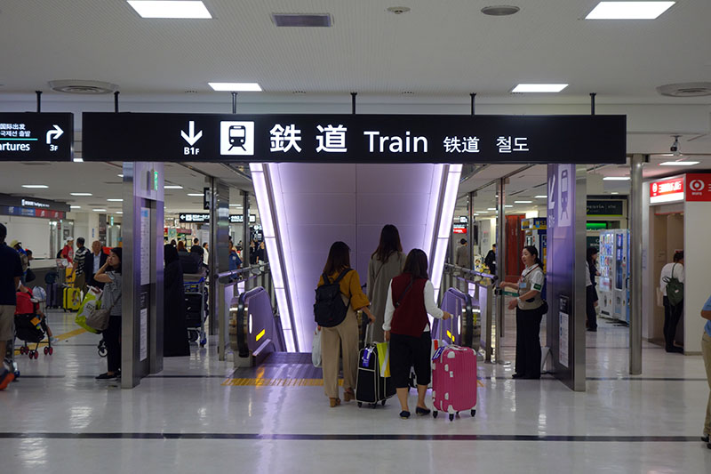 a group of people standing in a train station