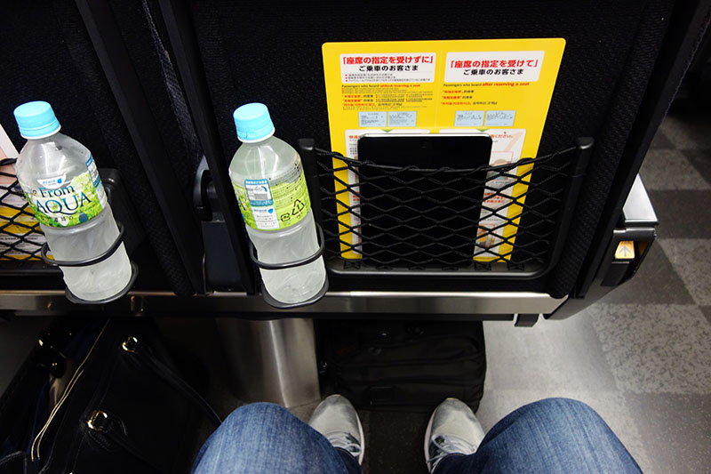 a bottle of water in a net on a seat