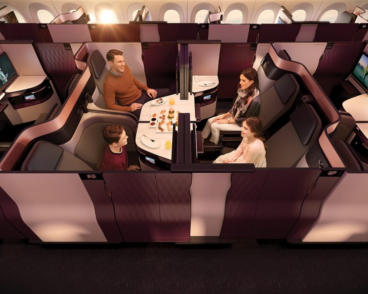 a family sitting at a table in a plane