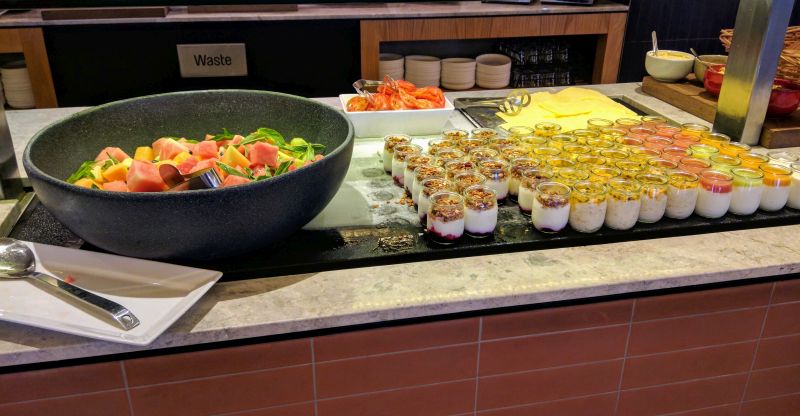 a buffet table with food in cups