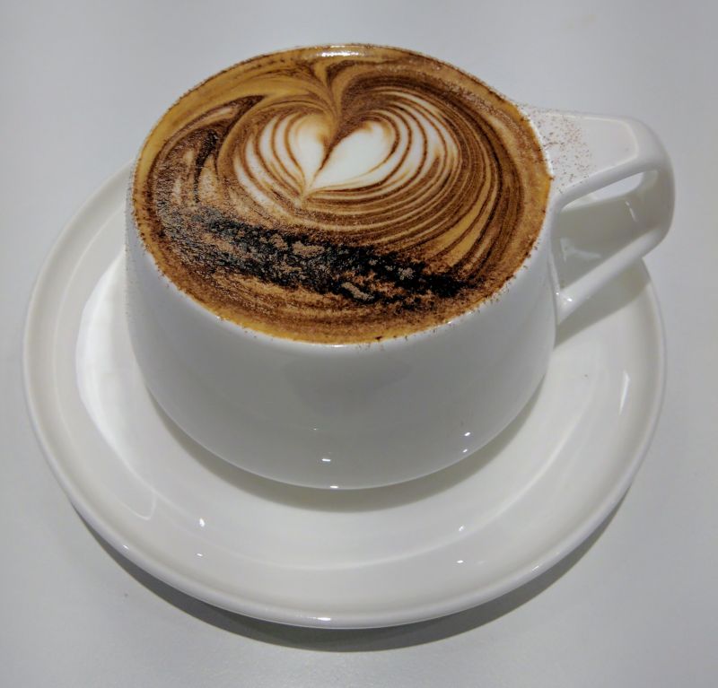 a cup of coffee with a heart design on top